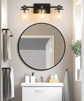 Three Light Matte Black And Brushed Nickel Bathroom Vanity Light Fixture over mirror with clear glass shades in modern bathroom