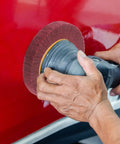 Heavy Duty VOSAREA Bench Grinder Buffing Wheel With Nonwoven Abrasive Cloth polishing a red surface with grit 320.