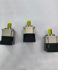 Three High Performance Hard Tooth Planetary Gear Reducers showcasing robust design and yellow shafts for heavy duty speed reduction projects.