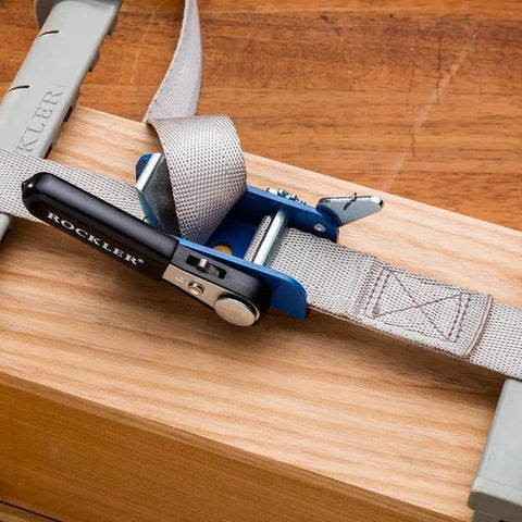 Workhorse Durable 1 Inch By 15 Inch Quick Grip Band Clamp securing a piece of wood with ratcheting handle for woodworking projects.