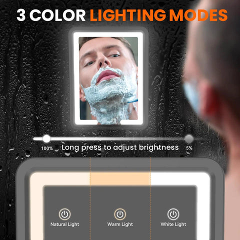 Person shaving in shower with Heated Fog-Free LED Shower Mirror With 3 Dimmable Lights, showing lighting modes on screen.
