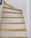 Cream Vinyl Grassweave Peel And Stick Wallpaper for Easy DIY Accent Walls, applied on stairs, repositionable and no mess.