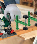 Beefy Two Piece 19 Millimeter Bench Dog Clamp With Quick Release in use with saw on a workbench, showing clamping action