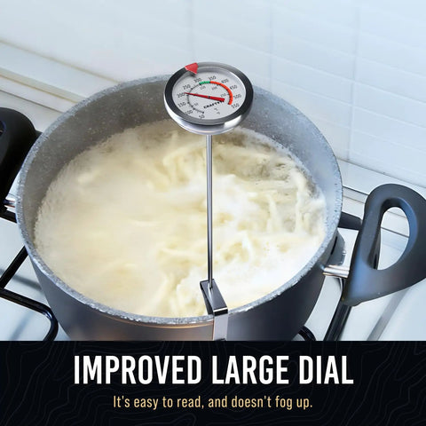 Candy Thermometer With Pot Clip For Deep Frying And Candy Making attached to pot on stove, accurate readings, white.