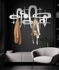 Slick Mid Century Metal Coat Rack With Abstract Wall Hooks, featuring two hanging jackets in a modern entryway setting.
