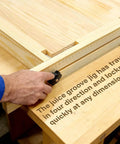 Man using Juice Groove Router Jig For Cutting Boards Adjustable Wooden Router Guide For Precise Juice Grooves And Square Grooves Easy To Use DIY Woodworking Tool Delivering Pro Grade Clean Uniform Channels Every Time on a wooden board.