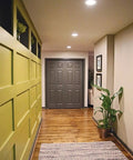 Slick 12W Recessed LED Downlight Boasting Deep Anti Glare Lens illuminating a hallway with stylish decor and wooden flooring.