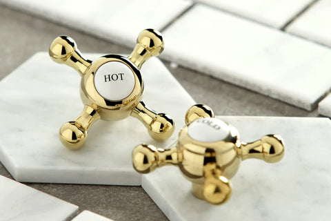 Widespread 8 Inch Polished Brass Bathroom Faucet handles showing hot and cold labels, part of the Retro Vibe Bath Fixture.
