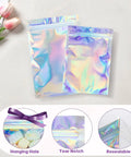 Holographic Packaging Bags 3.1x4.7 Inch Resealable Foil Mylar Pouches with hanging hole, tear notch, resealable feature, displayed on table.