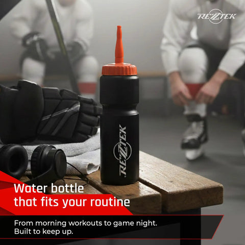 Hockey Hydration Bottle With Long Spout For Fast Sips 25 Oz in locker room on bench with sports gear