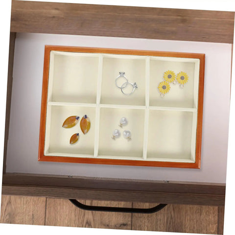 Premium Solid Wood Desktop Jewelry Organizer Tray With Divided Grid Compartments For Rings Necklaces Earrings And Watches Durable Storage Holder displaying rings and earrings organized in a compartmentalized tray.