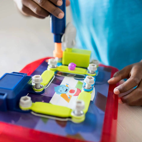 Child using a kid-friendly drill on Space Circuits Beginner Circuit Building Kit For Kids 52 Piece STEM Toy for hands-on learning.