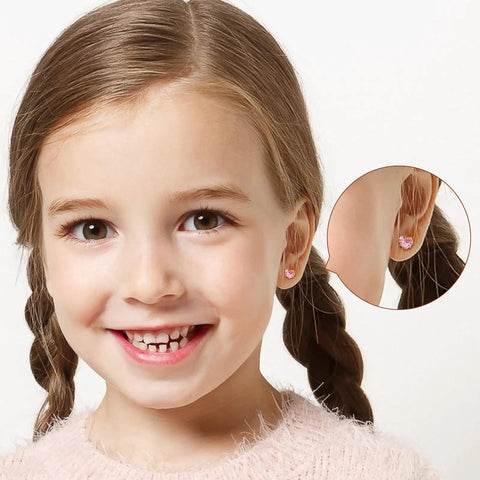 Hypoallergenic Surgical Steel Earrings for Girls and Toddlers with Screw Back Flat Posts Nickel Free and Safe for Sensitive Ears Kid Friendly Mixed 14K Gold and Silver Stud Set Featuring Heart Flower Pearl Star Shapes. Pink heart stud on girl wearing kids earrings