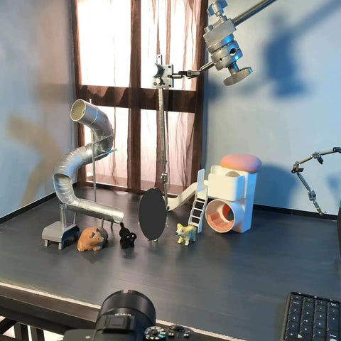 Stop Motion Armature Stand With Flexible Multi Joint Arm Height Adjustable Metal Bracket For Smooth Shots And Precise Angles Vertical Rack Design To Dial In Any Studio Setup Easily, metal arm angled over tabletop set