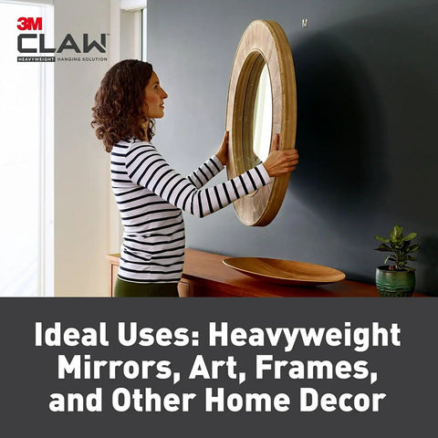 Woman hanging mirror using Heavy Duty Claw Drywall Picture Hanger 3 Pack For Heavy Mirrors And Artwork Steel Locking Claw.