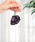 Hand holding Lightning Pattern Welding Helmet Keychain With Durable Chain And Key Ring For Keys, Bags, And Cars, Lightweight Acrylic Accessory