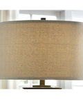 Glass Table Lamp With Bronze Finish Base And Fabric Drum Shade, clear glass cylinder, showing fabric shade detail