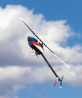 Fusion 700 Kit High Performance Super Combo with carbon fiber 700mm main rotor flying against a blue sky