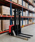 Walkie Stacker For Heavy Cargo Lifting Compact Pallet Stacking Equipment with red and black design in warehouse aisle