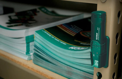 Grab And Go Humidity And Temperature USB Data Logger With 16,000 Readings Memory attached to shelf beside manuals