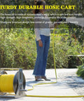 Heavy Duty Portable Hose Reel Cart with Extra Long Water Hose Beefy Stainless Steel Frame setup on patio with user pulling hose.
