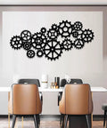 Kickass Steampunk Gear Wheel Metal Wall Decor For Living Room Or Man Cave Vintage Industrial Factory Style Wall Art Pieces Bringing Awesome Rustic Home Vibes, featuring multiple black steel gears arranged on a light wall.