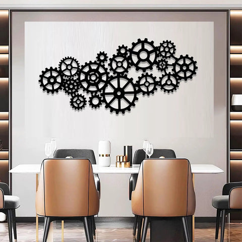 Kickass Steampunk Gear Wheel Metal Wall Decor For Living Room Or Man Cave Vintage Industrial Factory Style Wall Art Pieces Bringing Awesome Rustic Home Vibes, featuring multiple black steel gears arranged on a light wall.