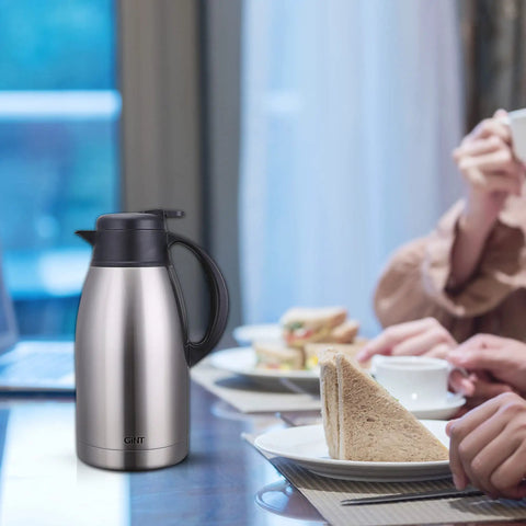 Stainless Steel Thermal Coffee Carafe With Double Wall Vacuum Insulation Keeps Your Brew Piping Hot Up To 12 Hours Or Cold Up To 24 Hours 65 Oz One Point Nine Liter Leak Proof Lid Silver on dining table during breakfast.