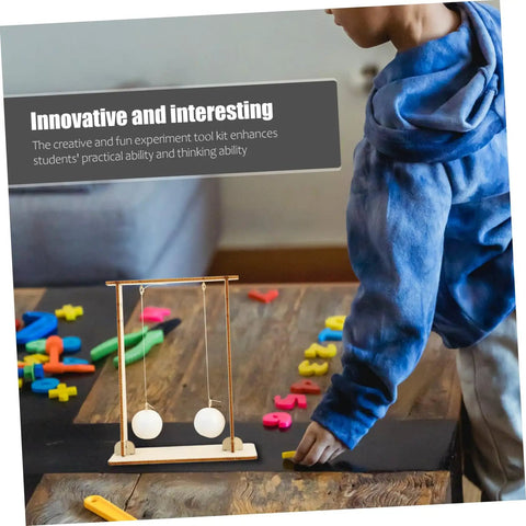 Child using Hands On Physics Experiment Tools Kit with Floating Ball for STEM learning on a wooden table.