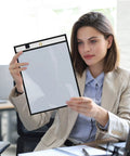 Woman holding Game Changer Oversized Dry Erase Pocket Sleeves 13 By 10 Inches For 8.5 By 11 Papers And 9 By 12 Worksheets in office.