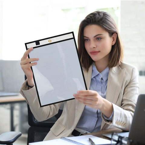 Woman holding Game Changer Oversized Dry Erase Pocket Sleeves 13 By 10 Inches For 8.5 By 11 Papers And 9 By 12 Worksheets in office.