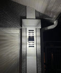LED Up And Down Outdoor Wall Lights Two Pack Sconce illuminating exterior house wall with ambient glow, highlighting sleek design.