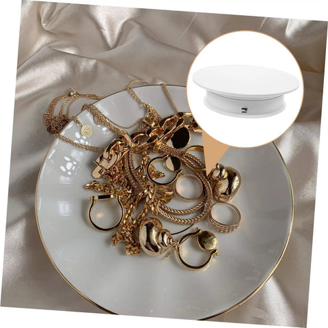 Rorpoir Adjustable Electric Rotating Display Stand For Jewelry And Watches With Anti Skid Base Energy Saving Motorized Turntable showcasing gold jewelry on a plate.