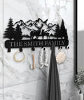 Custom Name Wall Key Holder With Forest Deer Design Dope Metal Coat Rack showcasing hooks on marble wall in home entryway.