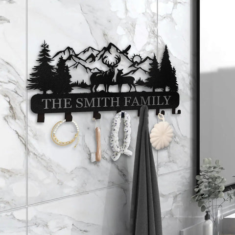 Custom Name Wall Key Holder With Forest Deer Design Dope Metal Coat Rack showcasing hooks on marble wall in home entryway.
