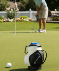 Two In One Golf Drink Holder Set With A 14oz Insulated Tumbler That Fits Cans And Bottles Keeps Mixed Drinks Cold On The Green A Dope Golf Accessory Gift For Men And Women shown on putting green, mini golf bag design visible.