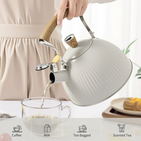 Stovetop Tea Kettle 2.5 Quart Whistling Kettle With Stainless Steel Body Creamy White Finish Wood Pattern Folding Handle pouring tea