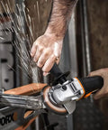 Hand using No Hassle Heavy Duty Cordless Angle Grinder With 20 Volt Lithium Ion Battery for cutting and grinding metal.