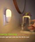 Plug In Motion Sensor Night Light Two Pack With Dusk To Dawn, dimmable soft warm white LEDs, installed in a bathroom setting