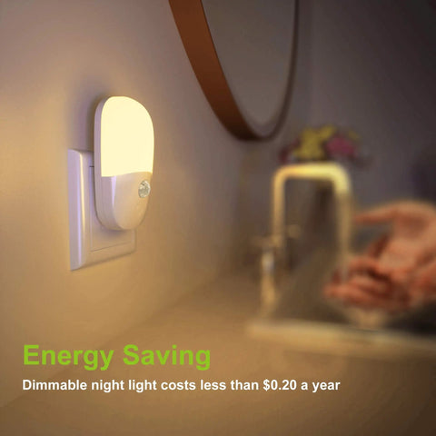 Plug In Motion Sensor Night Light Two Pack With Dusk To Dawn, dimmable soft warm white LEDs, installed in a bathroom setting