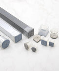 Square Felt Furniture Pads 1 1/4 To 1 3/8 Inch Self Adhesive Floor Protectors 4 Pack on a marble surface.