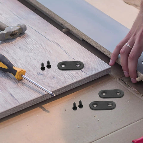 Heavy Duty Iron Corner Bracket Plates Set Of 20 Black Flat Straight Metal Brackets For Furniture And Shelves Easy No Tool Install Strong Fixation For Home Use being used on a wooden surface with tools.