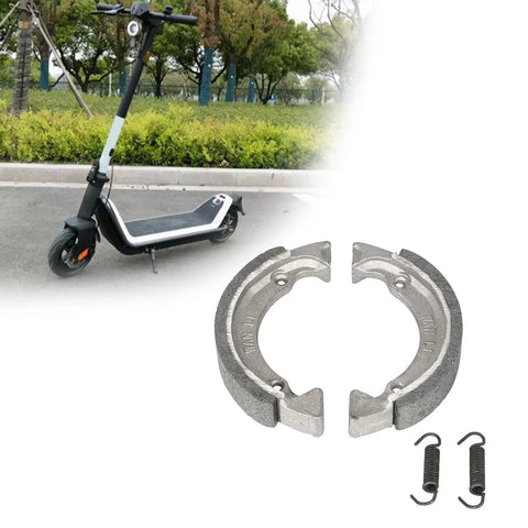 Front Drum Brake Pad Shoe Replacement for Electric Scooters with rugged brake shoes and springs on pavement background