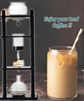 Certified Game Changer Cold Drip Coffee Machine And Iced Coffee Tower With Quick Adjustable Dripper, Massive One Liter Carafe And Sharp Black Stand alongside iced coffee drink.