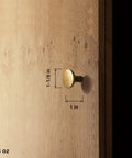 Antique Brass Cabinet Knobs 6 Pack Minimalist Round Hardware For Cabinets And Dressers 1-1/8 Inch Diameter installed on wood