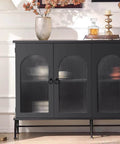 Black cabinet with textured glass doors and decorative items on top, featuring Gold Zinc Alloy Cabinet Knobs for Kitchen and Bathroom.