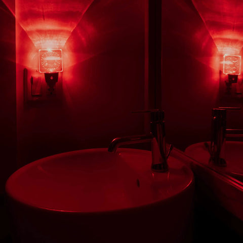 Red Dim Night Lights 2 Pack For Bedrooms And Bathrooms, Melatonin Friendly, glowing circle design, bathroom sink view.
