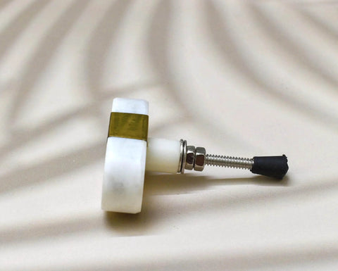 Close-up of Oval Stone and Brass Knob Set for Drawers and Cabinets 1.5 inch natural stone knobs with brass mount gold white finish.