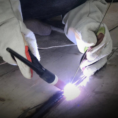 Person welding with Aluminum TIG Welding Rod ER4043 Three Thirty Second Inch By Sixteen Inch Five Pound Spool AlSi5 Filler Wire.