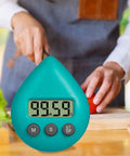 Person chopping vegetables in kitchen with waterproof digital timer with suction cup loud alarm for kitchen cooking visible in foreground